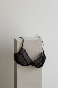 Kaboompics - Black Lace Bra Hanging on a Textured Pedestal