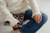 Kaboompics - Faceless Woman in White Sweater Sitting Cross-Legged with Book