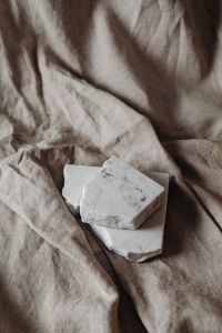 Kaboompics - Layered Marble Slabs on Draped Beige Linen with Soft Shadows