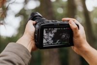 Kaboompics - Blackmagic Pocket Cinema Camera in Hands Filming an Outdoor Scene