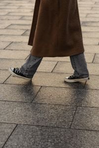 Kaboompics - Casual Sneakers and Wide Leg Jeans on City Pavement