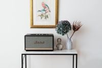 Kaboompics - Black speaker on marble table, white wall, sculpture, painting