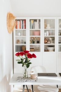 Kaboompics - Vertical Home Office Desk with Red Roses in Glass Vase and Laptop