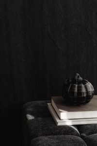 Kaboompics - Black Pumpkin and Books in Dark Halloween Scene