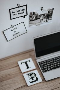 Kaboompics - Design Inspiration Desk with Motivational Quote Cards, Urban Photo Print and Silver Laptop