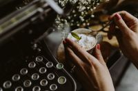 Kaboompics - Hands Holding an Ornate Cup and Spoon over Whipped Cream Coffee, Vintage Coffee Break Lifestyle