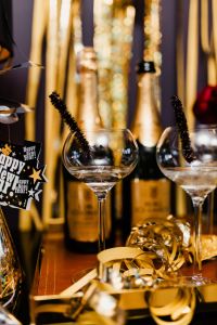 Kaboompics - Happy New Year Gift Tag, Champagne Flutes and Gold Streamers, Vertical Party Photo