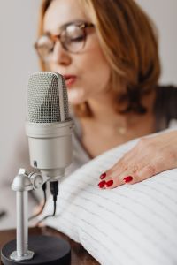 Kaboompics - Studio Microphone in Focus with Woman Whispering behind It, ASMR Portrait