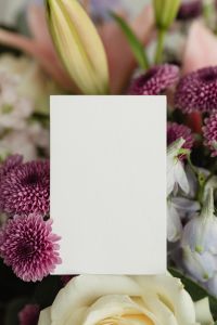 Kaboompics - Vertical Blank Card Mockup Framed by Purple Chrysanthemums and Pastel Flowers