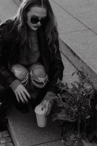 Kaboompics - Black and White Woman Crouching Beside Flowers and Coffee