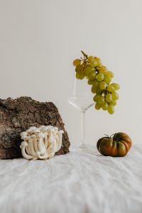 Kaboompics - Bark, White Mushroom, Glass and Green Grapes Still Life