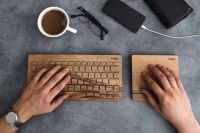 Kaboompics - Young man typing on the wooden keyboard