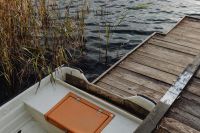 Kaboompics - Rowboat and Wooden Dock Along a Reed Covered Lake Shore