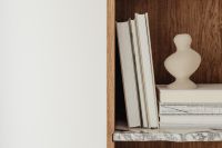 Kaboompics - Minimalist Bookcase with White Books, Ceramic Vase and Open Copy Space