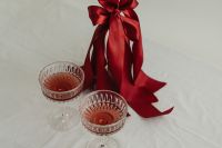 Kaboompics - White Candle with Red Satin Bow and Pink Cocktails