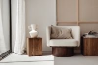 Kaboompics - Minimalist Living Room with White Armchair, Wooden Tables and Open Book