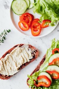 Hummus Breakfast Sandwich with Fresh Vegetables on Marble Backgrounds