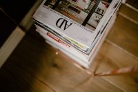 Kaboompics - Interior Design Magazines Stacked on a Wooden Floor