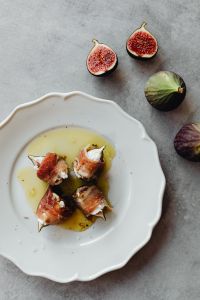 Kaboompics - Prosciutto-Wrapped Figs With Goat Cheese On White Plate