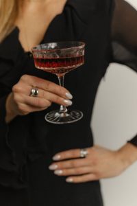 Kaboompics - Woman Holding a Red Cocktail in a Black Dress