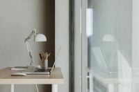Kaboompics - Wooden Home Office Desk with Laptop, Adjustable Lamp and Notebook beside a Large Window