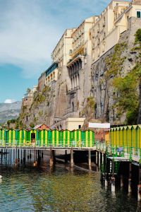 Kaboompics - Colorful Italian Beach Cabins Beneath Sorrento Cliffside