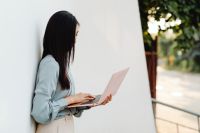 Kaboompics - Close-Up of Asian Woman Using a Pink Laptop