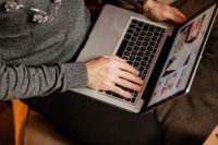 Kaboompics - Close-Up of Man Typing on MacBook at Holiday Gathering