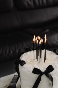 Kaboompics - White Celebration Cake with Black Candles and Bow