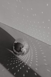 Kaboompics - Disco Ball on the Floor in a Sunlit Corner with Strong Shadows
