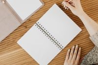 Kaboompics - Overhead View of Hand Writing in Open Planner