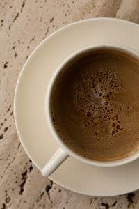Kaboompics - Top View of Coffee Cup on Beige Travertine Table