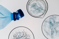 Kaboompics - Plastic Bottle With Microplastics In Petri Dish Minimal Layout