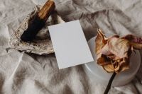Kaboompics - Landscape Card Mockup between Textured Stone and Dried Rose