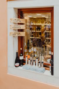 Kaboompics - Rovinj Specialty Food Shop Window with Wine, Olive Oil and Sea Salt