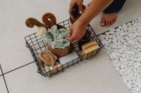 Kaboompics - Wire Basket of Cleaning Supplies on a Tiled Floor