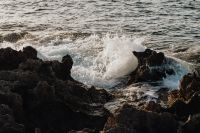 Kaboompics - White Foam Breaking Over Dark Coastal Rocks