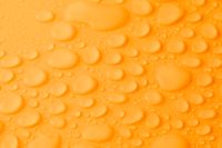 Kaboompics - Orange Water Drop Background With Rounded Macro Texture