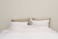 Kaboompics - Minimal White Bedding Against a Neutral Wall