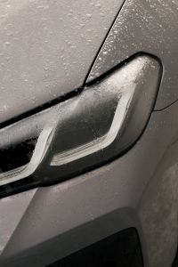 Kaboompics - Car Headlight with Water Drops and Snowy Winter Detail