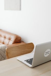 Kaboompics - Vertical Laptop and Wooden Chair by a Leather Sofa, Bright Work From Home Background