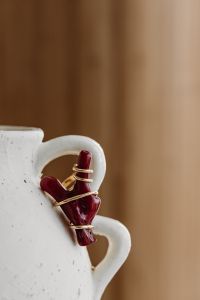 Kaboompics - Red Beaded Earrings on a Ceramic Vase Handle