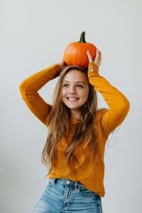 Young Woman Holding Pumpkin in Autumn Lifestyle Portraits