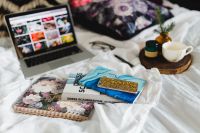 Kaboompics - Bed full of pillows and notebooks with Apple gadgets