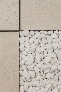 Kaboompics - Grid of Beige Stone Tiles with a White Pebble Inset, Neutral Design Background