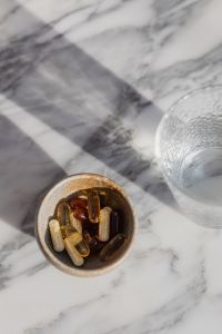 Kaboompics - Vitamins and Capsules in a Dark Ceramic Bowl