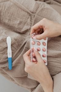 Kaboompics - Blister Pack of Pills and Pregnancy Test on a Bed