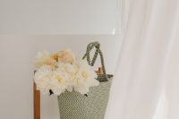 Kaboompics - White Flowers in a Woven Tote beside a Chair and Sheer Curtains