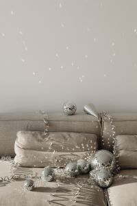 Kaboompics - Disco Ball and Silver Party Horn on Gray Sofa with Confetti