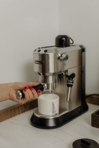 Kaboompics - Hand Attaching Portafilter to Espresso Machine